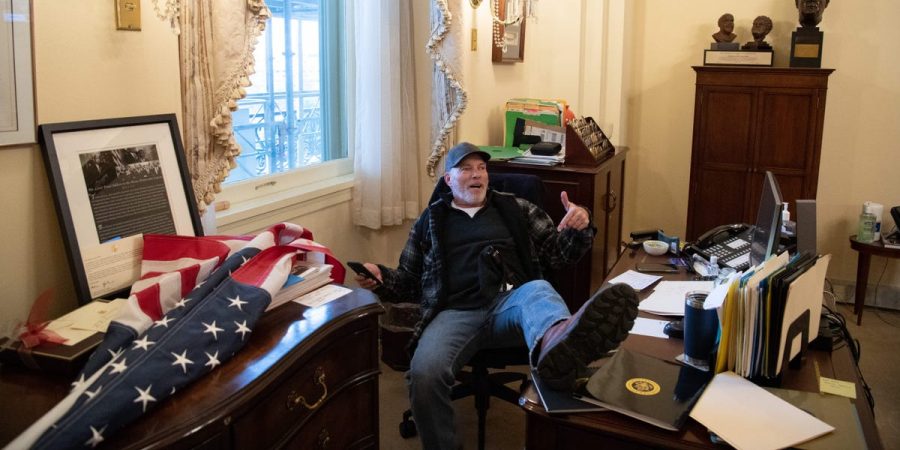 Rioter puts his feet up on Speaker of the House, 
Nancy Pelosi’s desk. He proceeded to steal Pelosi’s mail. Photo taken by Saul Loeb.