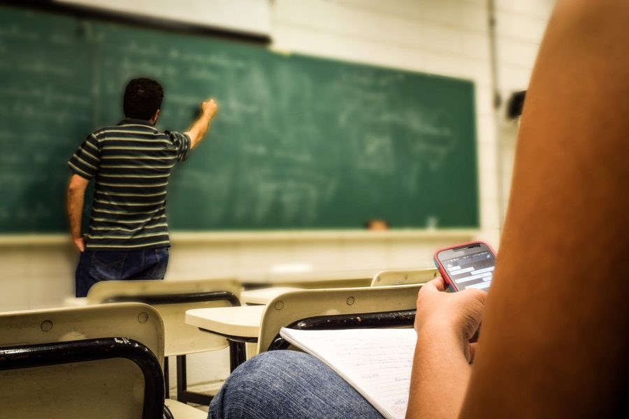 Free student texting during class image, public domain CC0 photo.