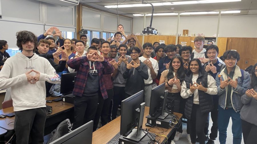 Members pose with the DECA hand symbol.